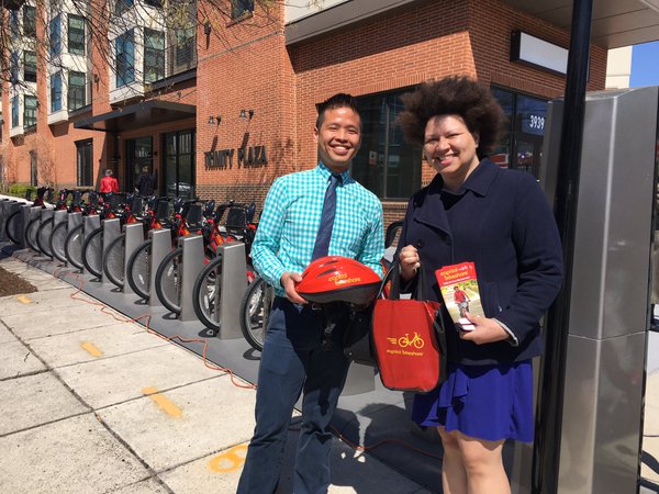 Dr. James Huang, left, shows off the helmets that will be provided as part of D.C.'s new Community Partners Program, offering discounted bike share memberships to low-income people. Photo: Unity Health Care
