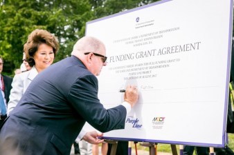 Maryland Governor Larry Hogan inks the deal on Maryland's long planned "Purple Line" light rail. Photo:  Greater Greater Washington