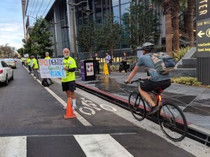 Protestors form a people-protected bike lane outside the NACTO conference this morning. Photo by People Protected LA