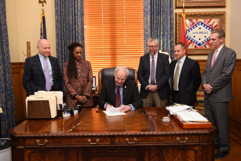 Arkansas Governor Asa Hutchinson signs Idaho Stop Legislation. Photo courtesy of Arkansas State Parks