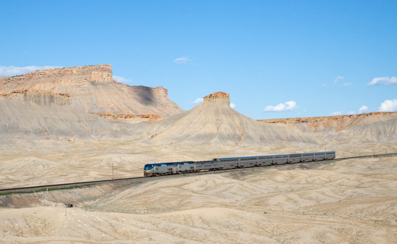 Caption: Amtrak’s California Zephyr crosses the Utah desert near Green River, Utah. Image source: Wikimedia/Kabelleger.