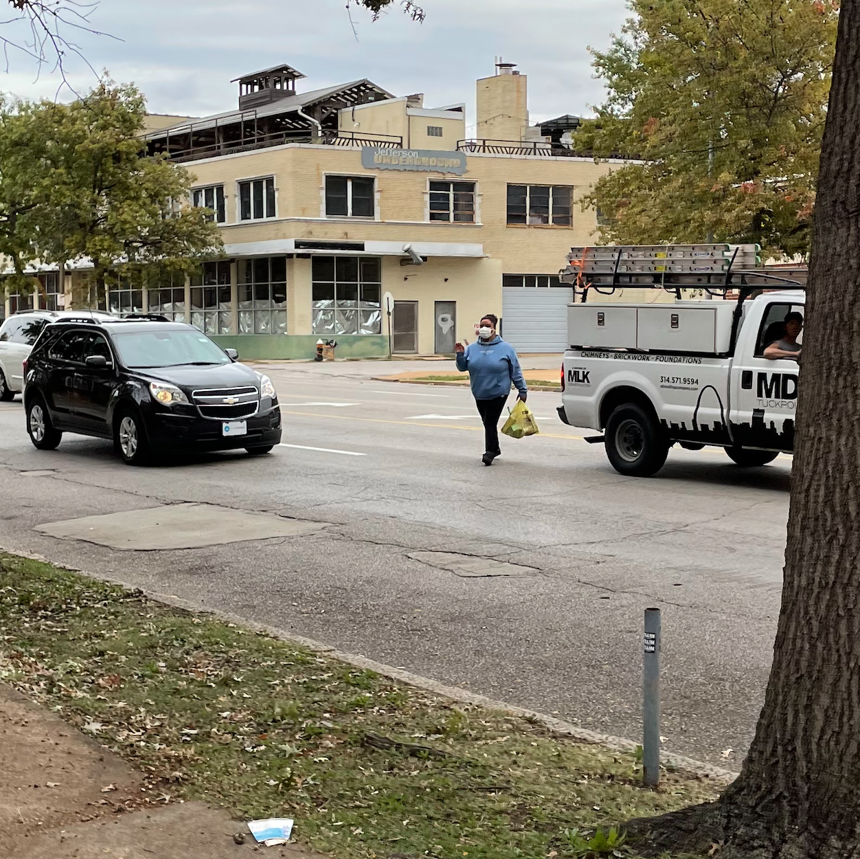 A pedestrian crosses the street on a five-lane, 35 mph arterial in St. Louis. There is no convenient crosswalk nearby. Image: Kea Wilson.