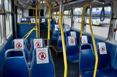 Interior of a TriMet bus (in the Portland, Oregon, metropolitan area) with numerous seats marked by "Don't sit here" signs intended to encourage spatial-distancing (in accordance with a temporary 10-passenger limit for buses) during the Covid-19 pandemic. Image: Steve Morgan, CC
