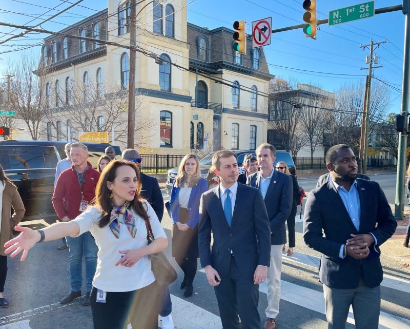 U.S. Transportation Secretary Pete Buttigieg, center, takes a tour of Richmond’s Jackson Ward Neighborhood, accompanied by Mayor Levar Stoney (right) and Maritza Mercado Pechin, (left) a city planning official. Image courtesy Wyatt Gordon for the Virginia Mercury)
